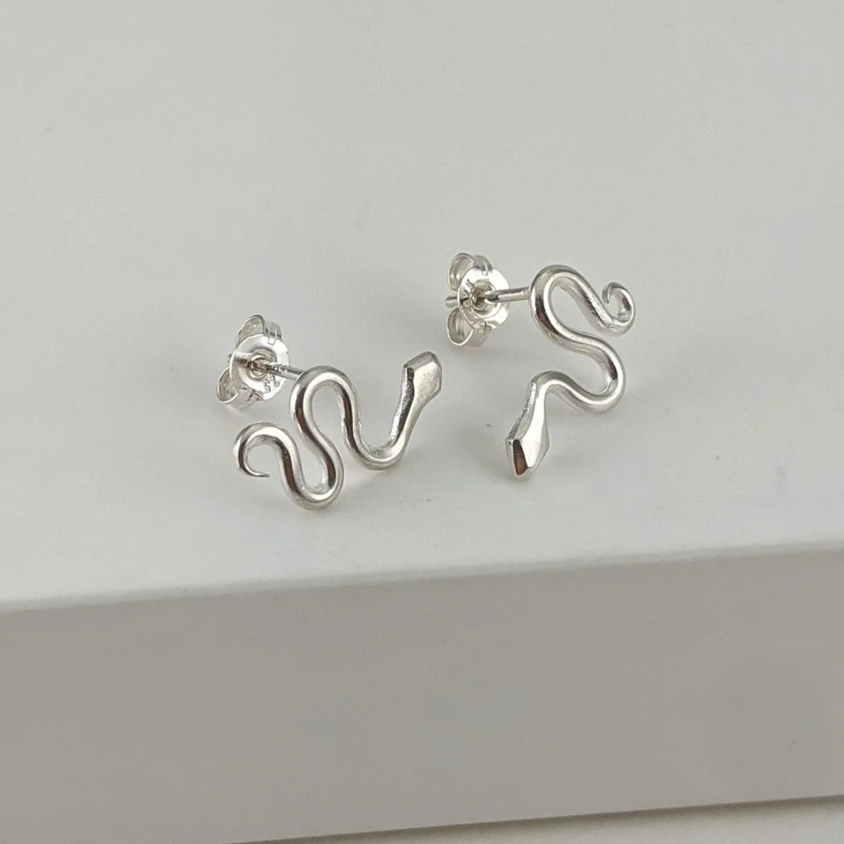 Small silver snake stud earrings