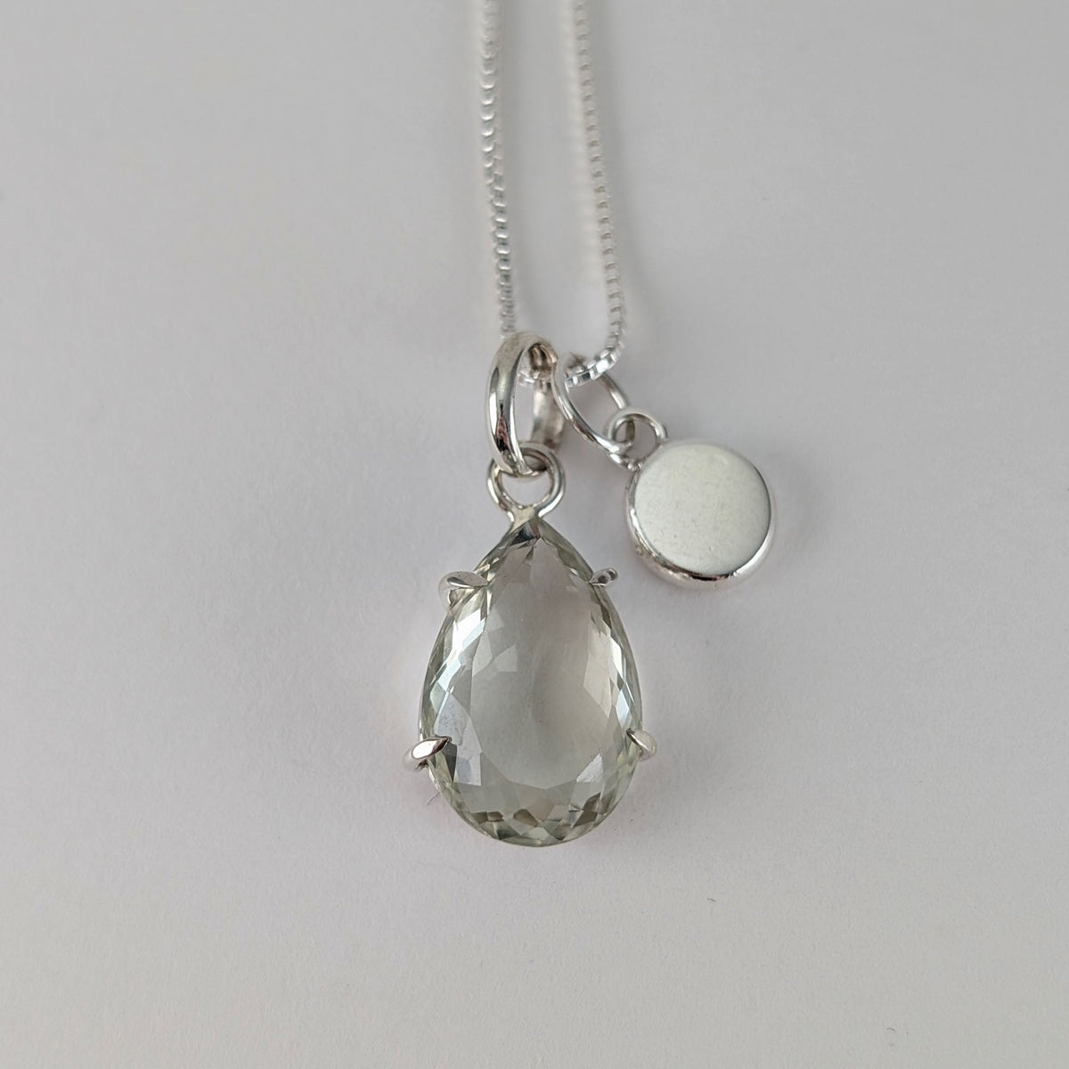 Teardrop shaped facet cut prasiolite pendant, hammered nugget pendant on a box chain necklace