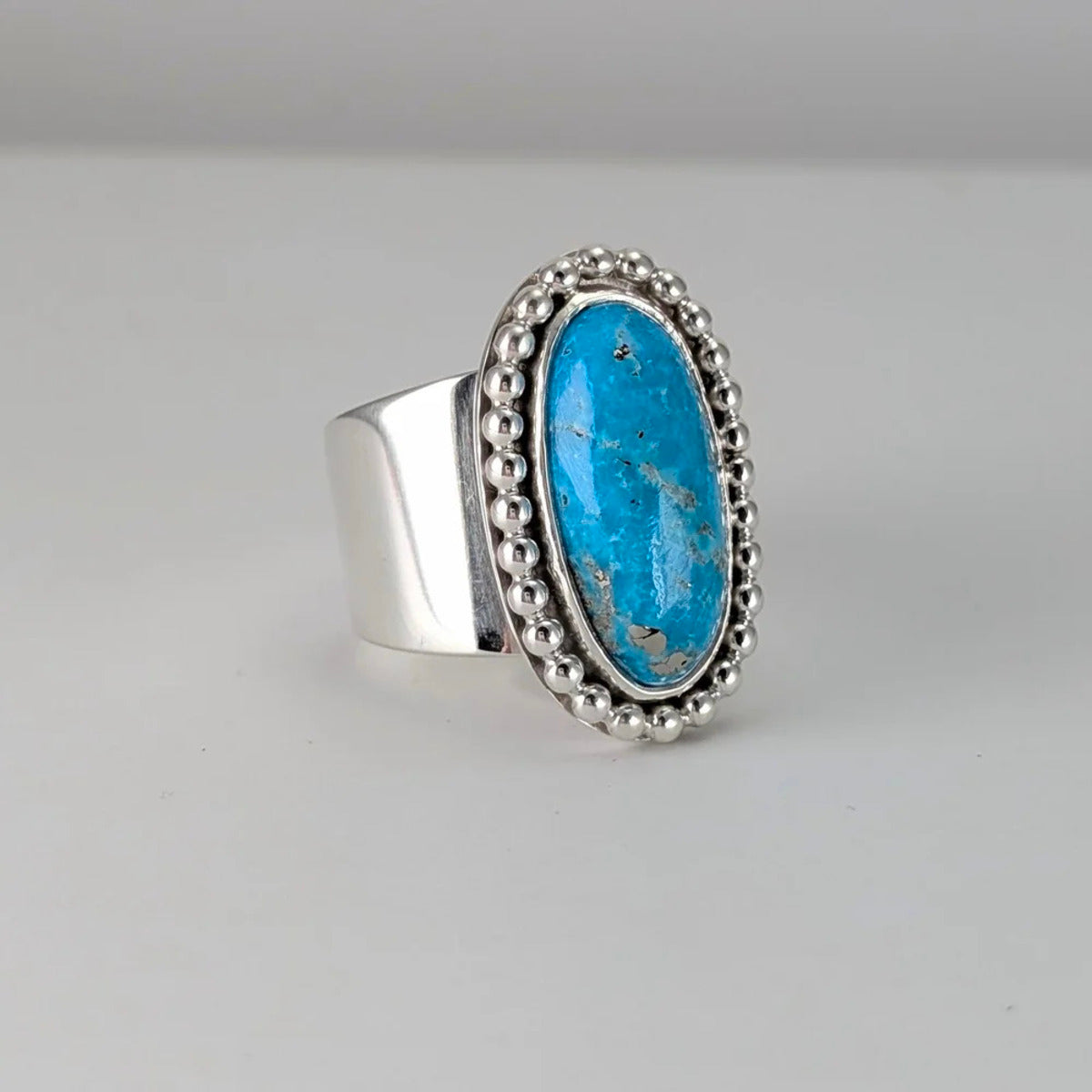 Persian turquoise oval cabochon tapered wide ring with beaded border